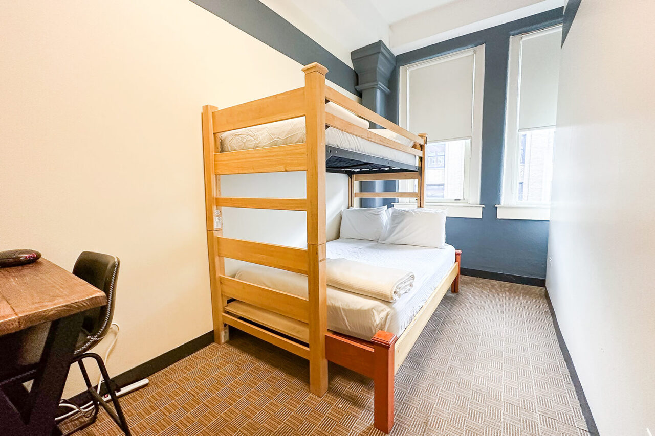 one twin-sized bed bunked over one full-sized bed in a private room at HI Chicago hostel