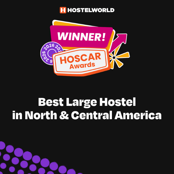 A colorful badge announcing HI New Orleans hostel as the winner of the Best Large Hostel in North & Central America for 2025 by Hostelworld.