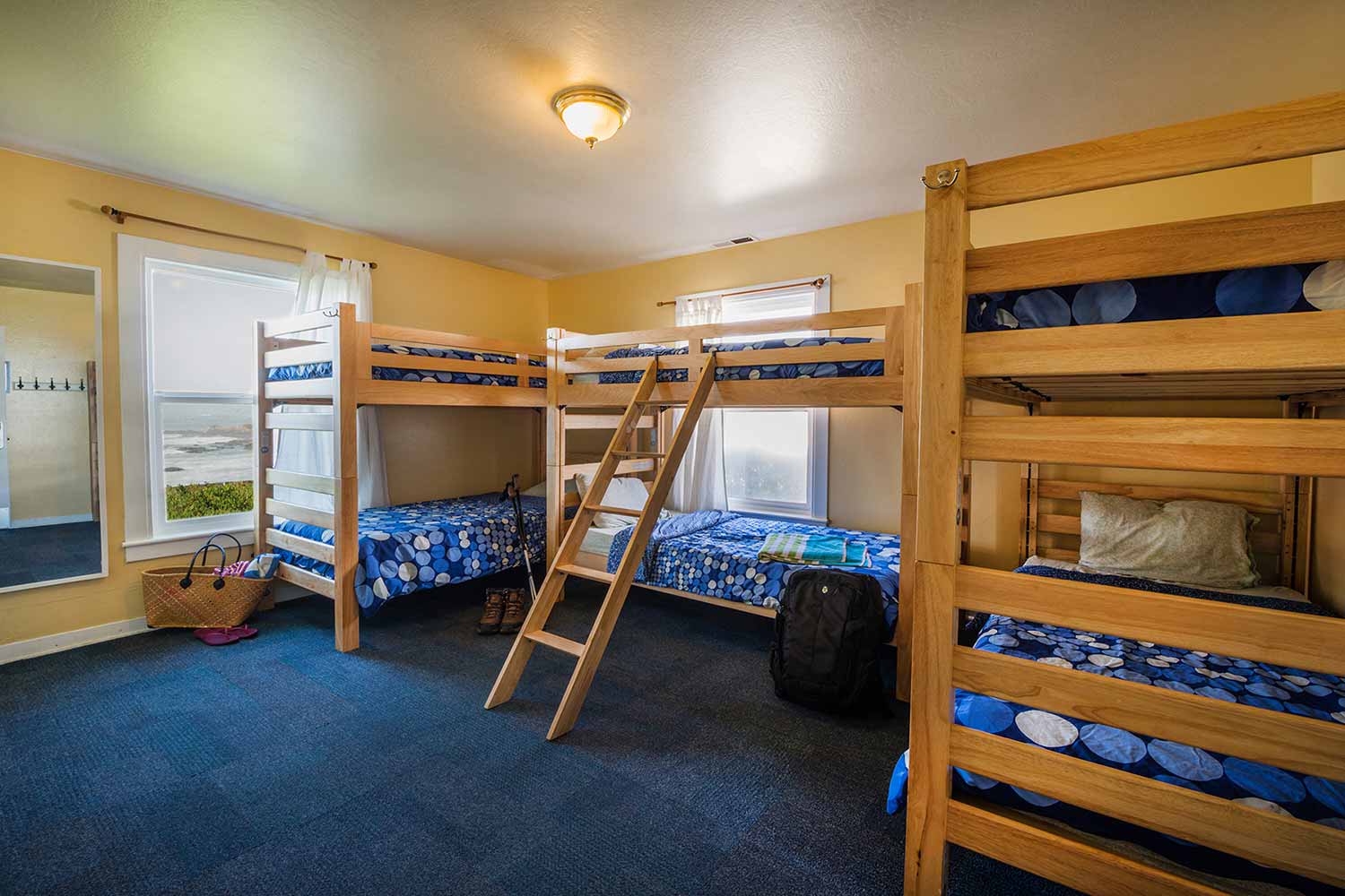 three sets of Bunk beds in a dorm room at HI Pigeon Point Light house Hostel.