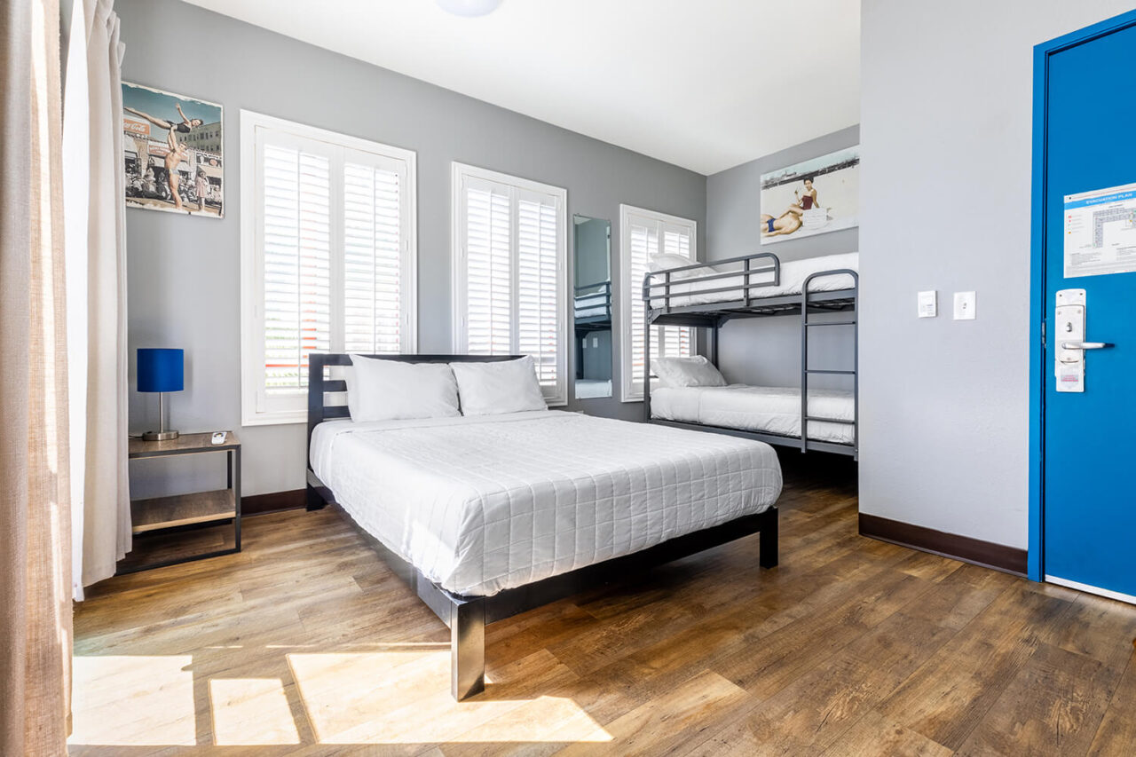 a private deluxe room at HI Los Angeles Santa Monica hostel with one large bed and one set of bunk beds