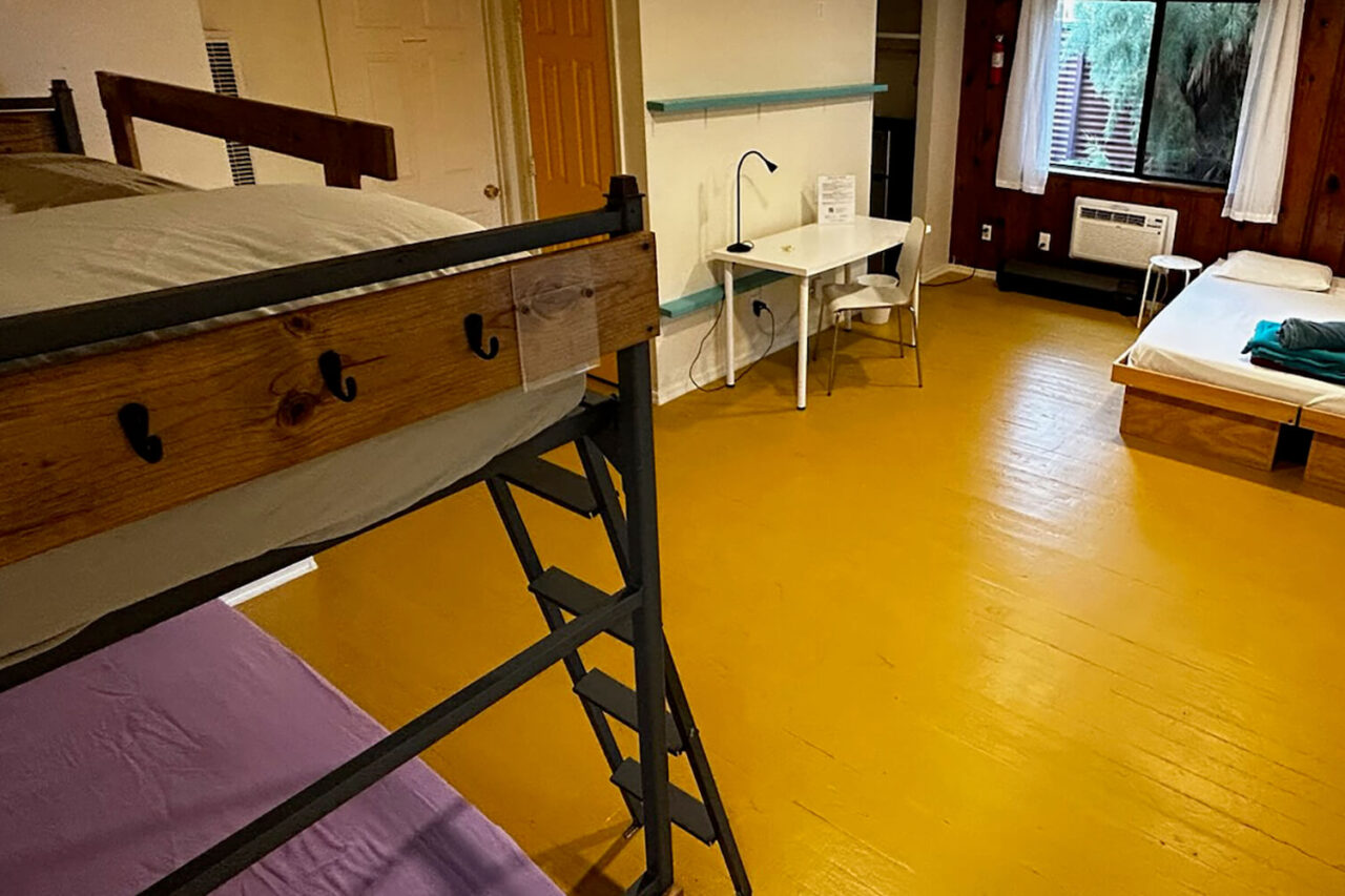 The Navajo room at HI Phoenix hostel, the Metcalf hostel, has one queen-sized bed and two twin-sized beds