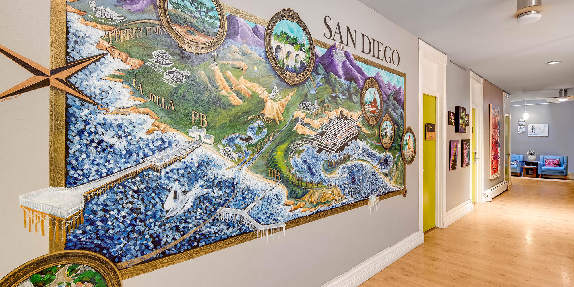an artist's rendering of a map of San Diego as a mural adorns a hallway wall at HI San Diego Downtown hostel