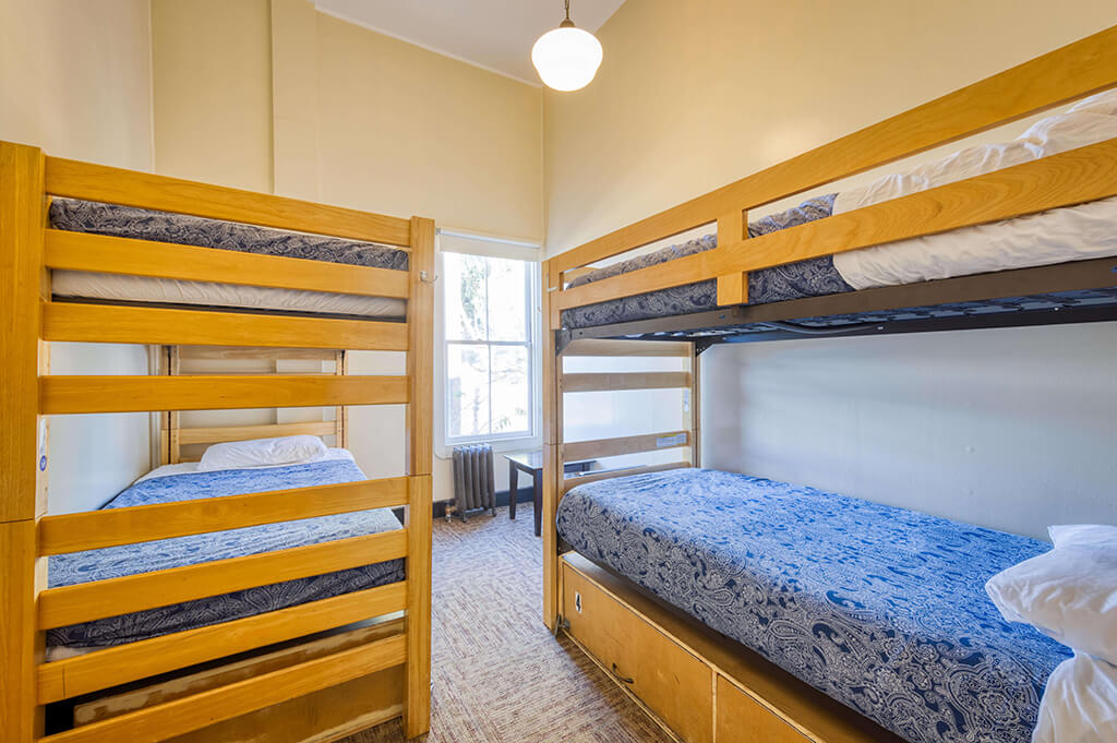a four-bed dorm at HI San Francisco Fisherman's Wharf hostel with four freshly made bunks