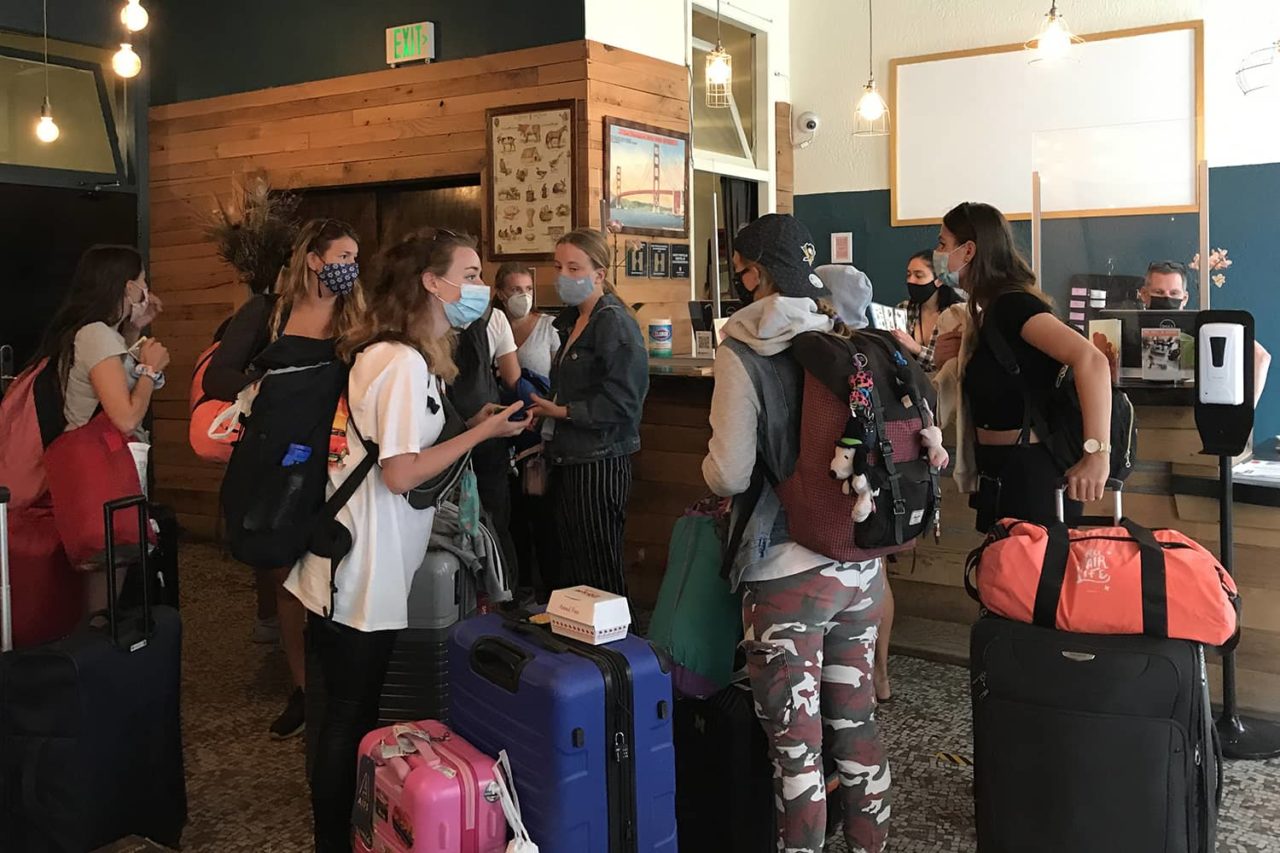 a group of young people checks in at the front desk at HI San Francisco Downtown hostel