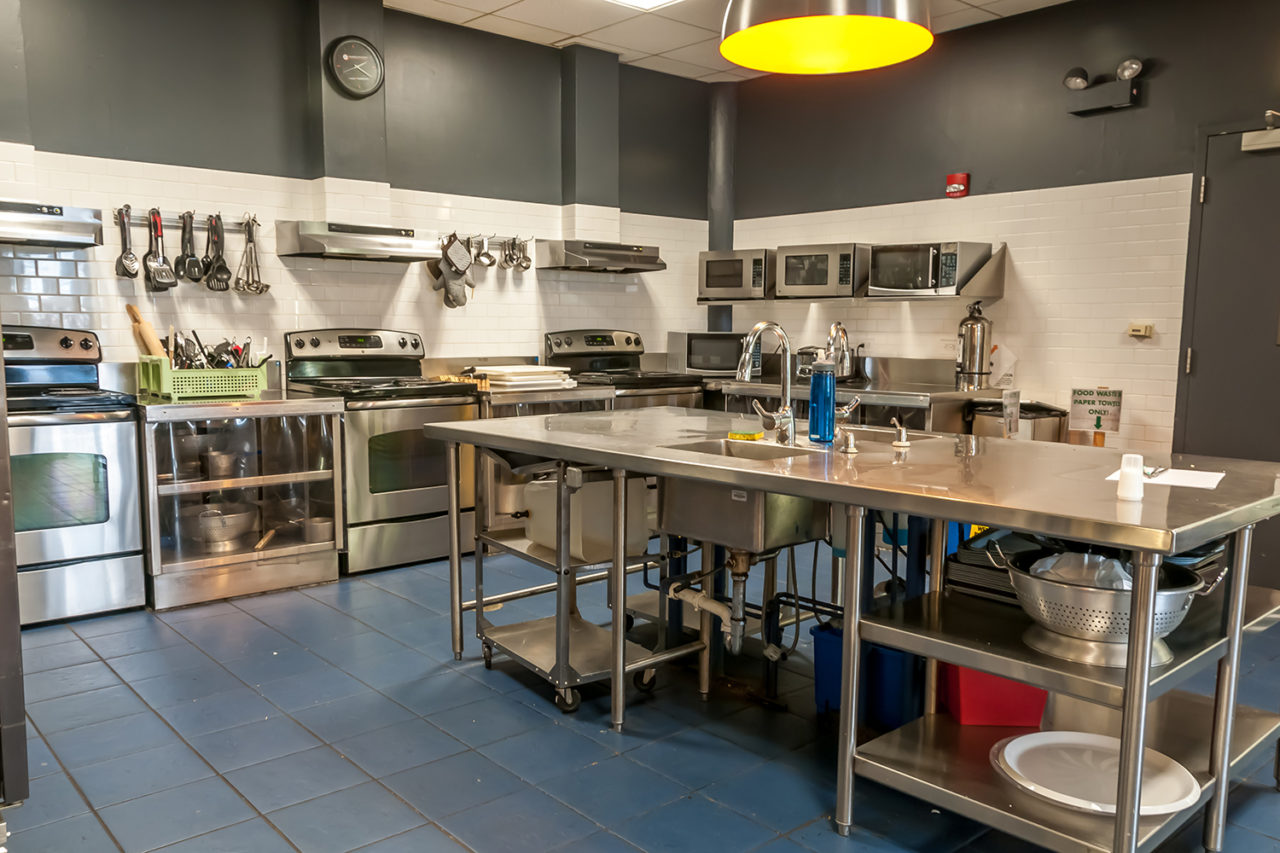the spacious guest kitchen at HI Chicago hostel is fully equipped with stoves, sinks, countertops, pots and pans, cutlery, and everything else you need to prepare your own meals