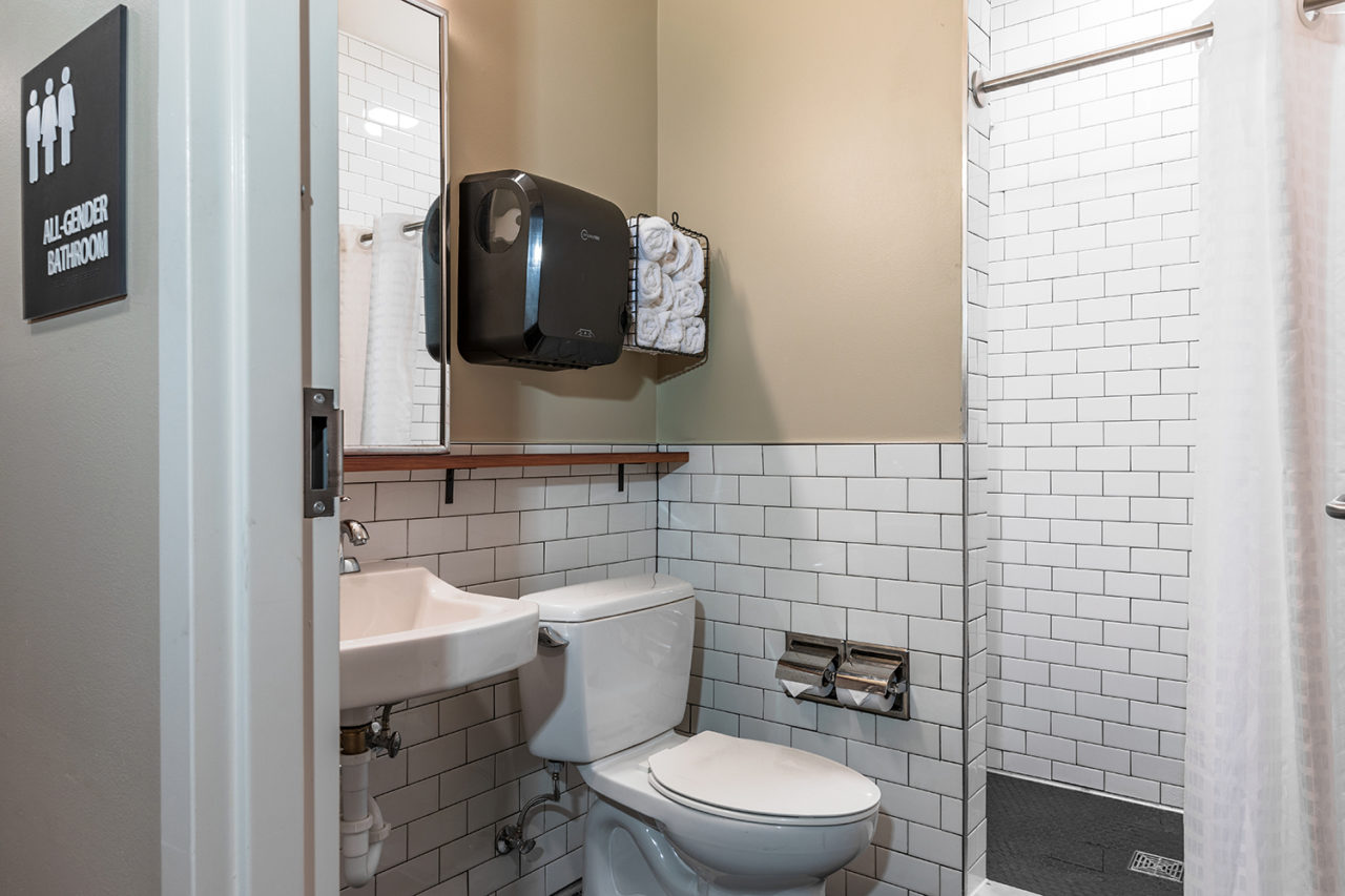 dorm room ensuite single-occupancy bathrooms at HI New Orleans hostel come with a sink, toilet, and shower. The bathrooms are cleaned regularly.