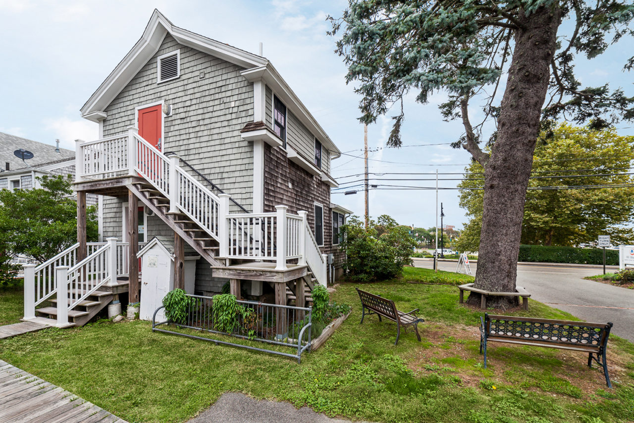 HI Hyannis hostel offers several outdoor seating areas like this one with benches and chairs