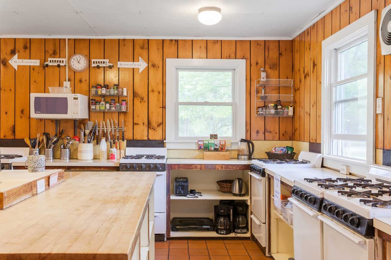 The fully equipped guest kitchen at HI Martha's Vineyard hostel has everything you need to prepare meals on site, including stoves, refrigerators, sinks, pots and pans, plates, and cutlery.