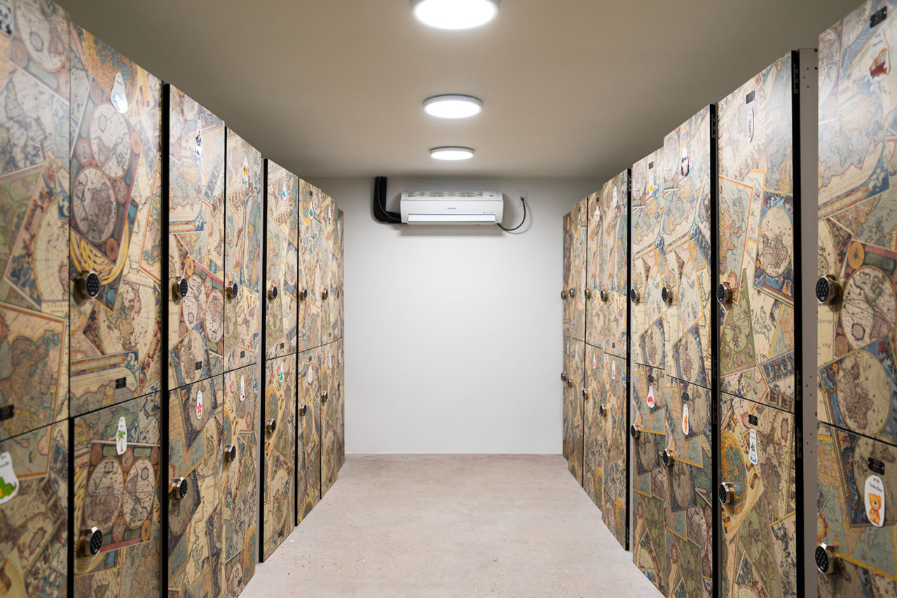 a secure storage room at HI New Orleans hostel with rows of individual lockers to secure guest belongings. Groups can store their luggage before or after check-out.