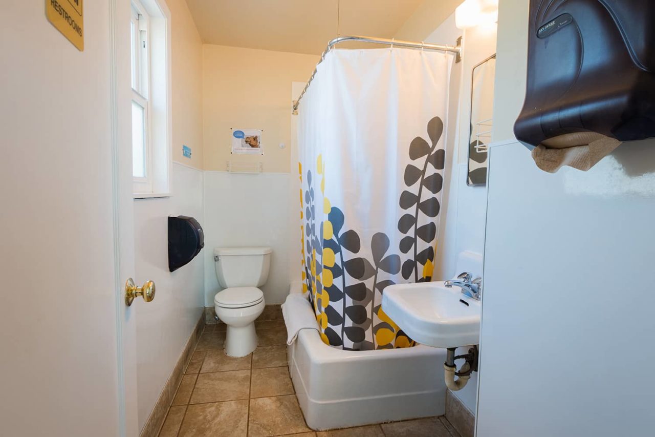 a clean bathroom with a tub and shower, toilet, and sink