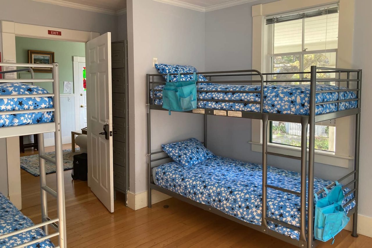 a bunk room at hi santa cruz hostel showing four beds