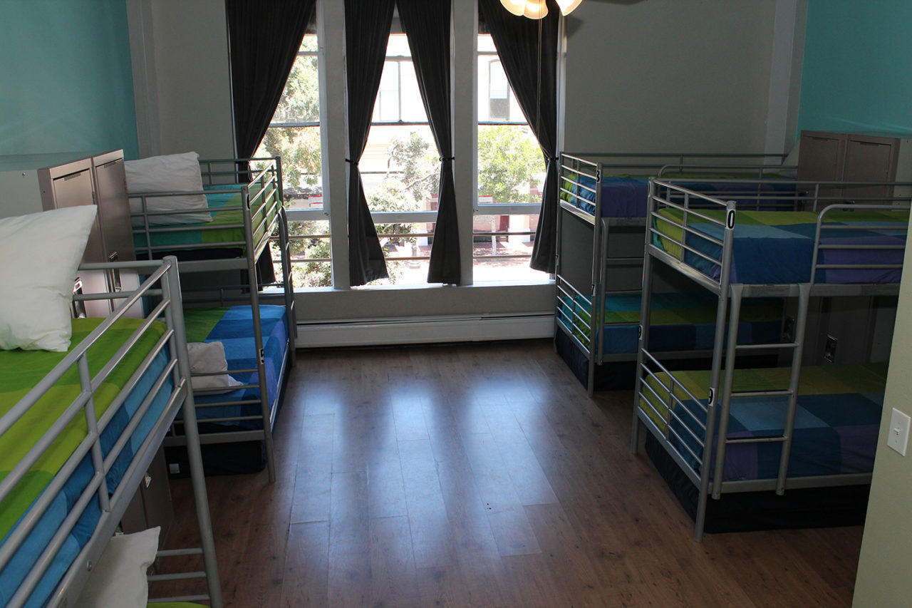a large dorm room at HI San Diego Downtown hostel with four sets of twin-sized bunk beds.