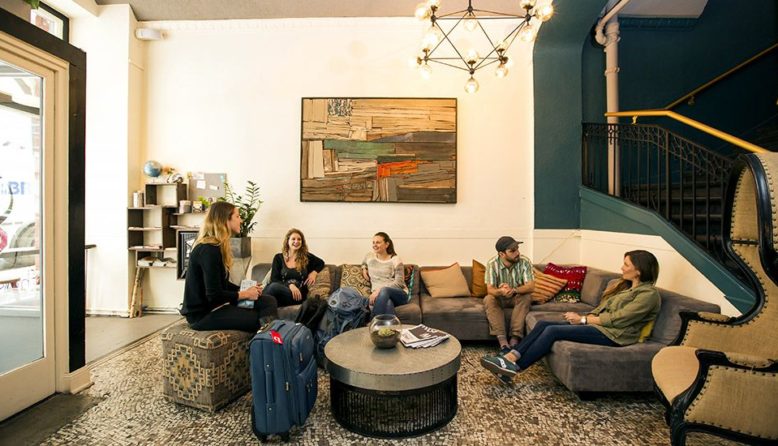 A group of people in a hostel lobby