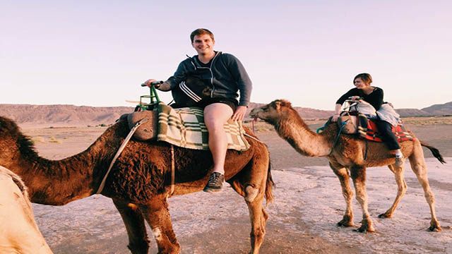 a couple riding camels