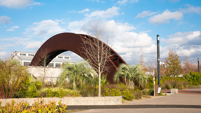 a curved iron bridge in Crescent Park in New Orleans