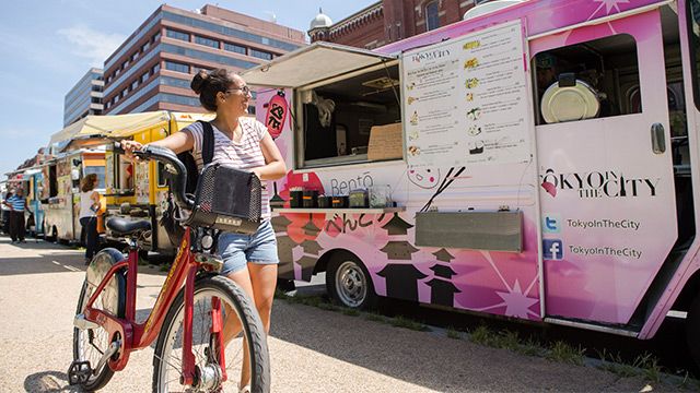 a cyclist by food trucks in Washington DC