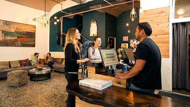 guests at a hostel front desk