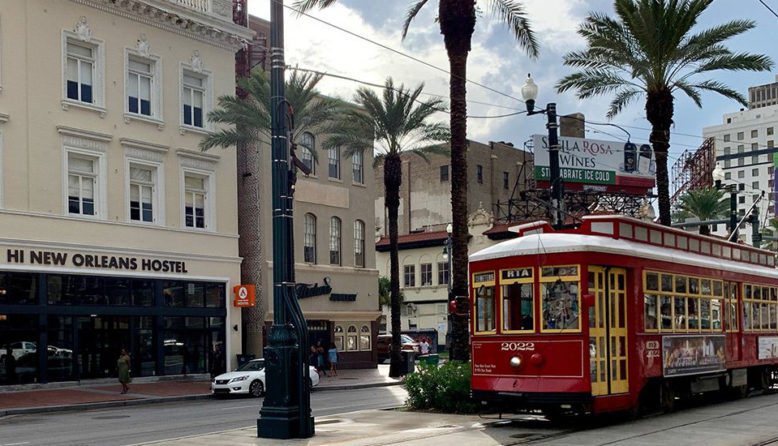 a streetcar passes HI New Orleans hostel