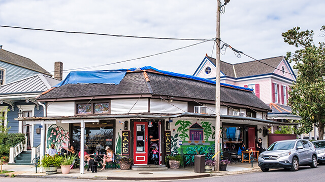 people dining outside at a colorful cafe in Algiers Point in New Orleans