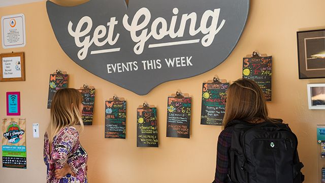 two travelers looking at an events calendar