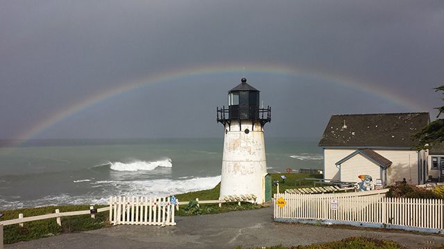 a rainbow over point montara lighthouse