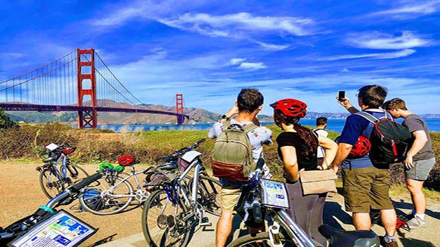 cyclists looking at the golden gate bridge