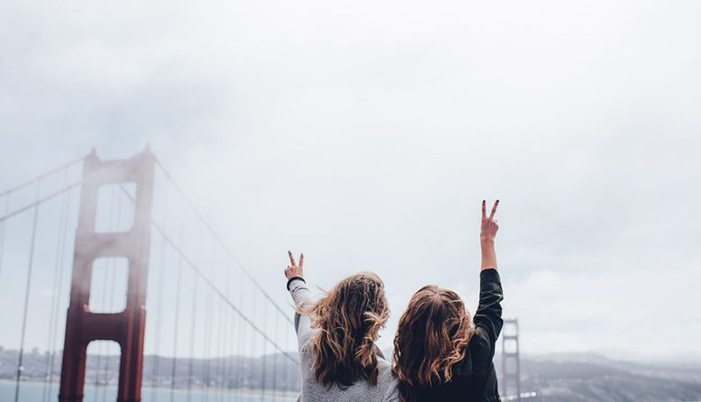 Two women standing at the Golden Gate Bridge