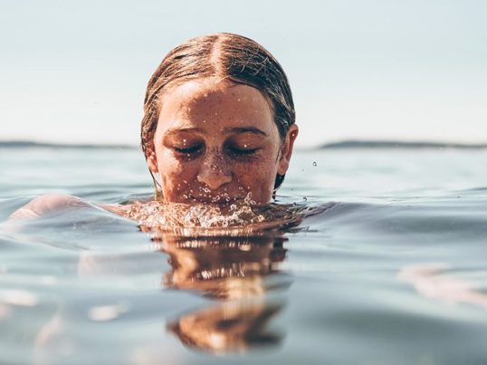 woman swimming in a lake