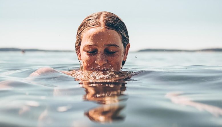 woman swimming in a lake