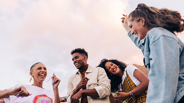 a group of four happy young travelers 