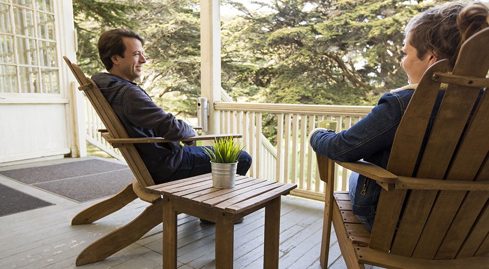 Two people sitting on a deck at HI Marin Headlands Hostel