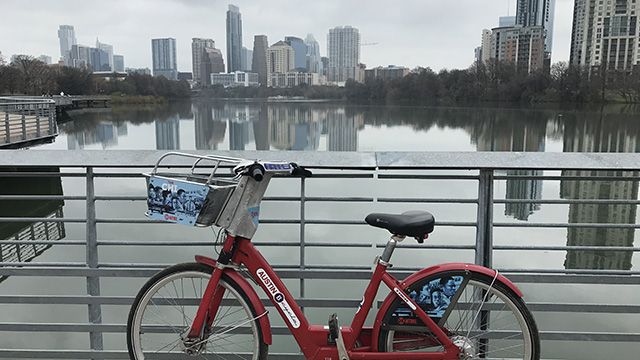 a bicycle in front of the Austin skyline