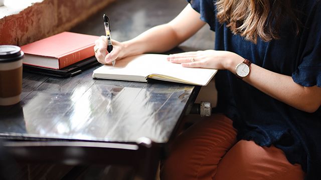 woman writing in a journal