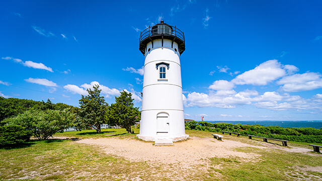 the edgartown harbor lighthouse stands against a bright blue sky on Martha's Vineyard