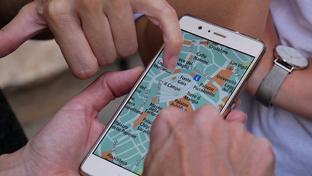 hands looking at a map on a smartphone