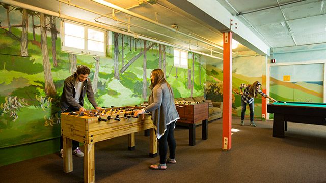 travelers in the game room at HI Marin Headlands hostel