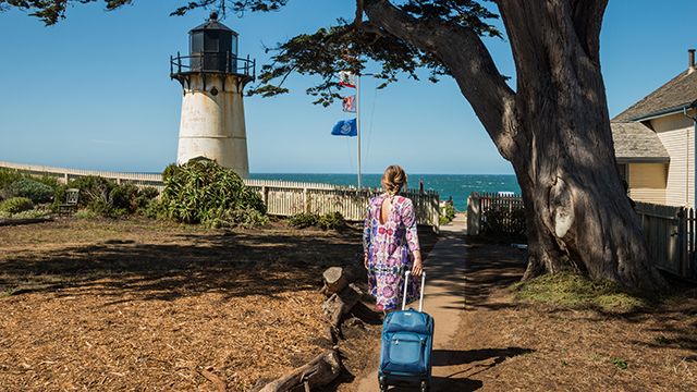 woman with a suitcase at Point Montara lighthouse hostel