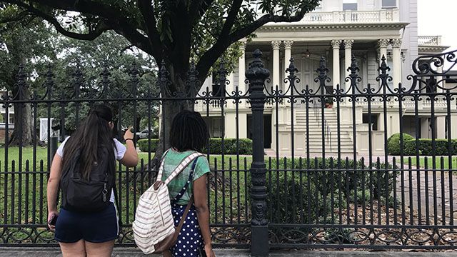 two women looking at a house in new orleans