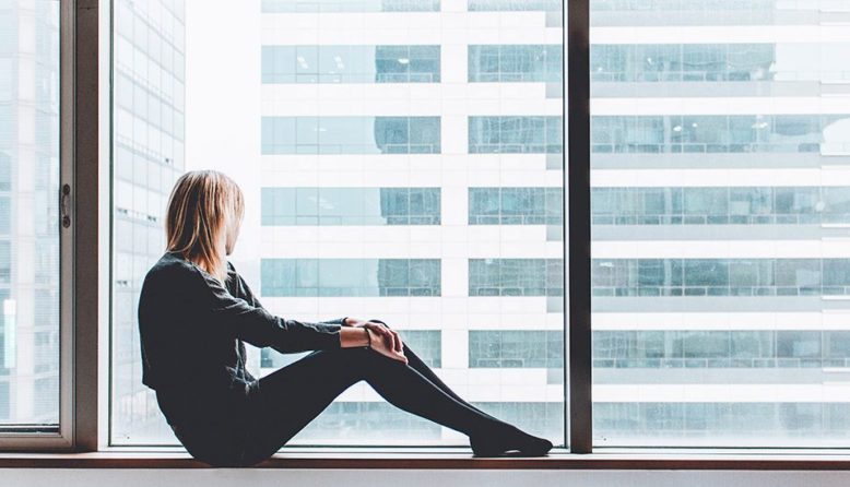 woman sitting in front of a window