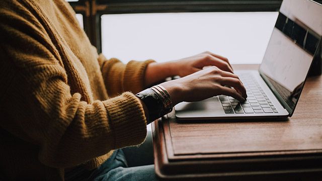 woman typing on a laptop computer