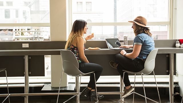 two women in front of a laptop at HI Chicago hostel