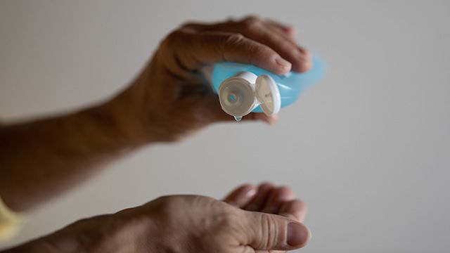a person using hand sanitizer