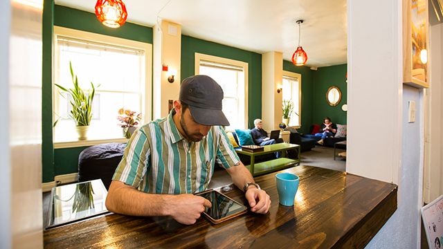 man using an ipad at HI San Francisco Downtown hostel