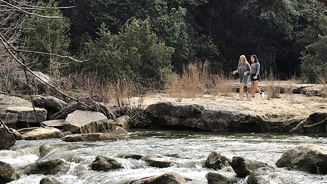 two women walking in zilker park in austin