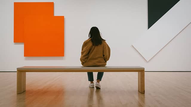 a museum visitor looking at artwork at SFMOMA