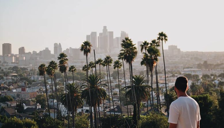 a man looking out over the LA city skyline