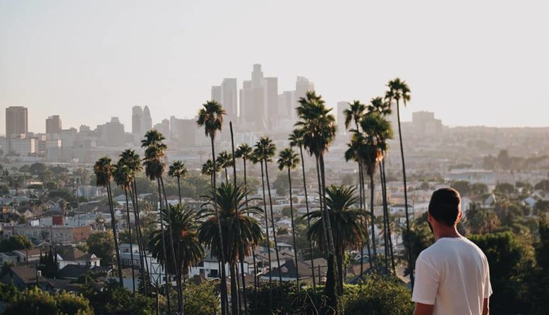 a man looking out over the LA city skyline