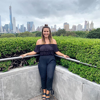 writer Lola Mendez in front of a city skyline