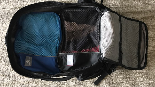 a backpack filled with packing cubes