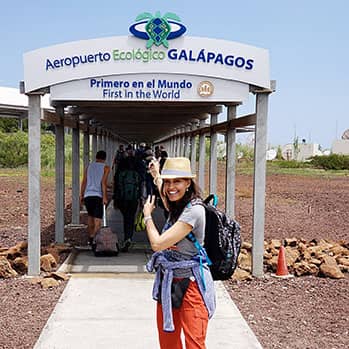 journalist Tinabeth Pina stands in front of the Airport in the Galapagos Islands